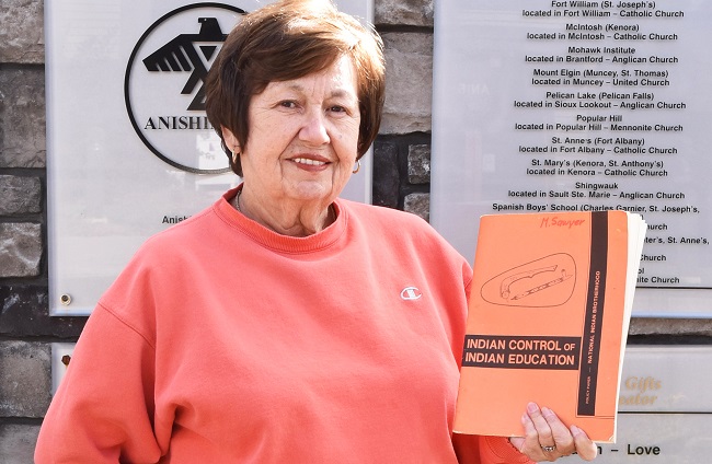 Dr. Muriel Sawyer holding her book, "Indian Control of Indian Education"