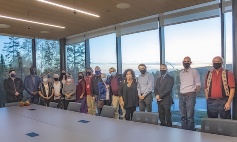 Dr. Muriel Sawyer Boardroom featuring two walls of flood to ceiling windows showcasing the beautiful views of Nipissing University Campus and Lake Nipissing.